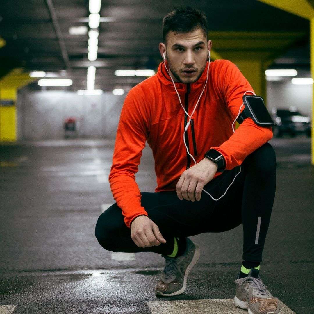 man with headphones in execising in garage